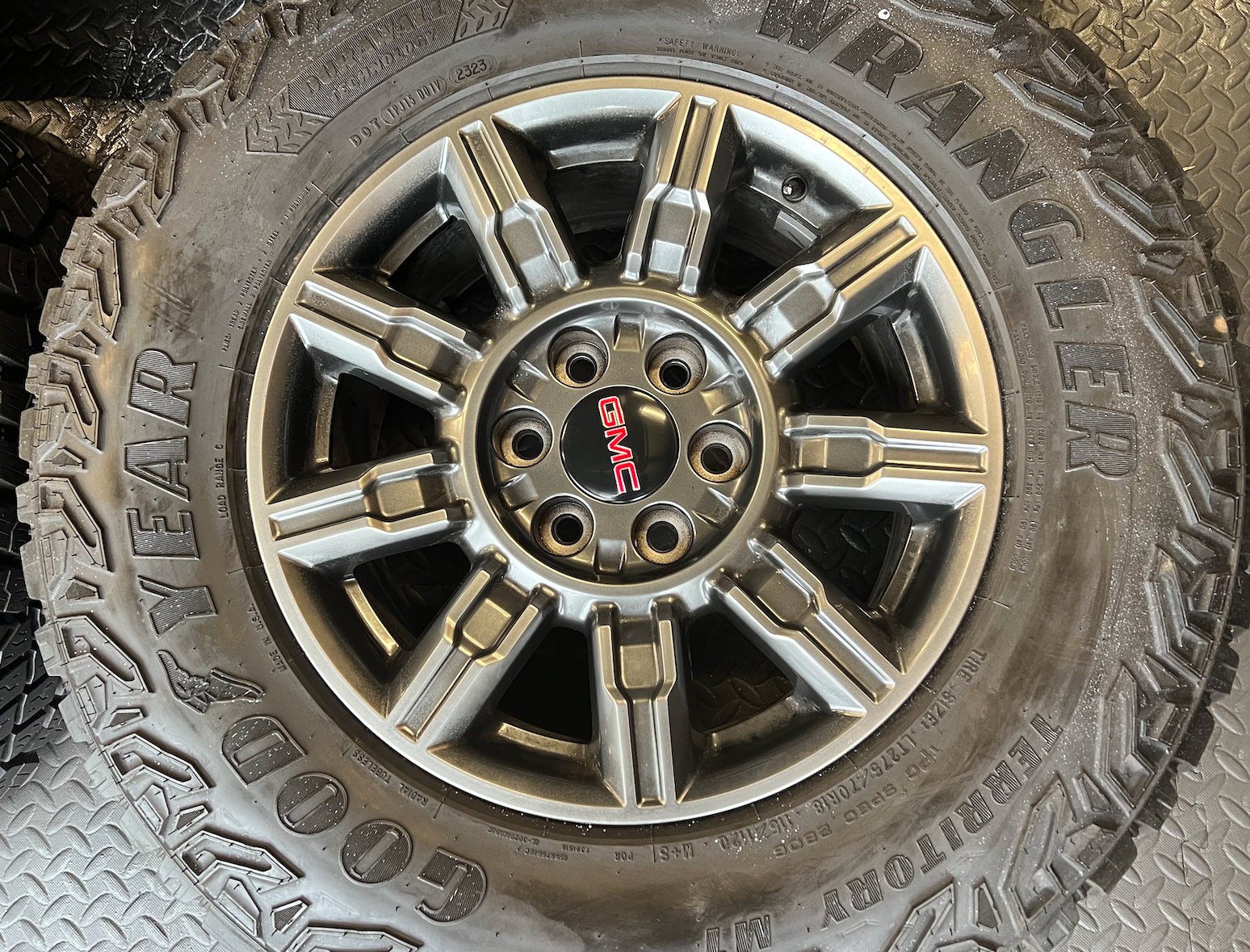 OEM 18" at4x machined aluminum Wheels wrapped in Goodyear tires.