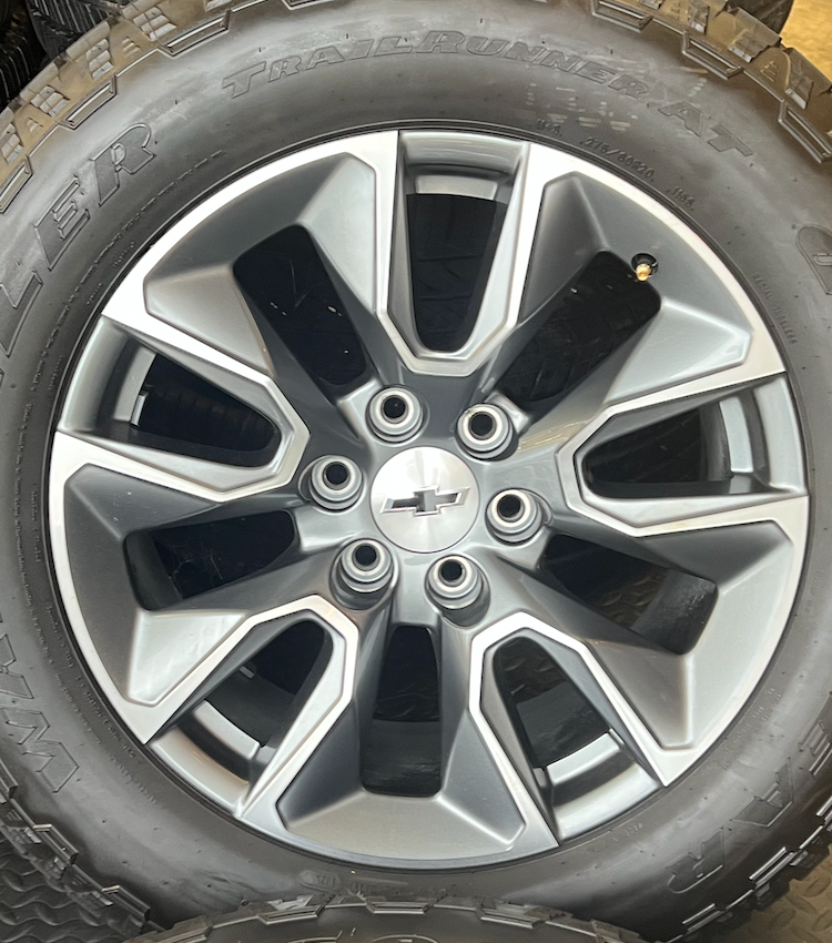 OEM 20”  Gunmetal & Machined Wheels wrapped in Goodyear Wrangler TrailRunner A/T tires.