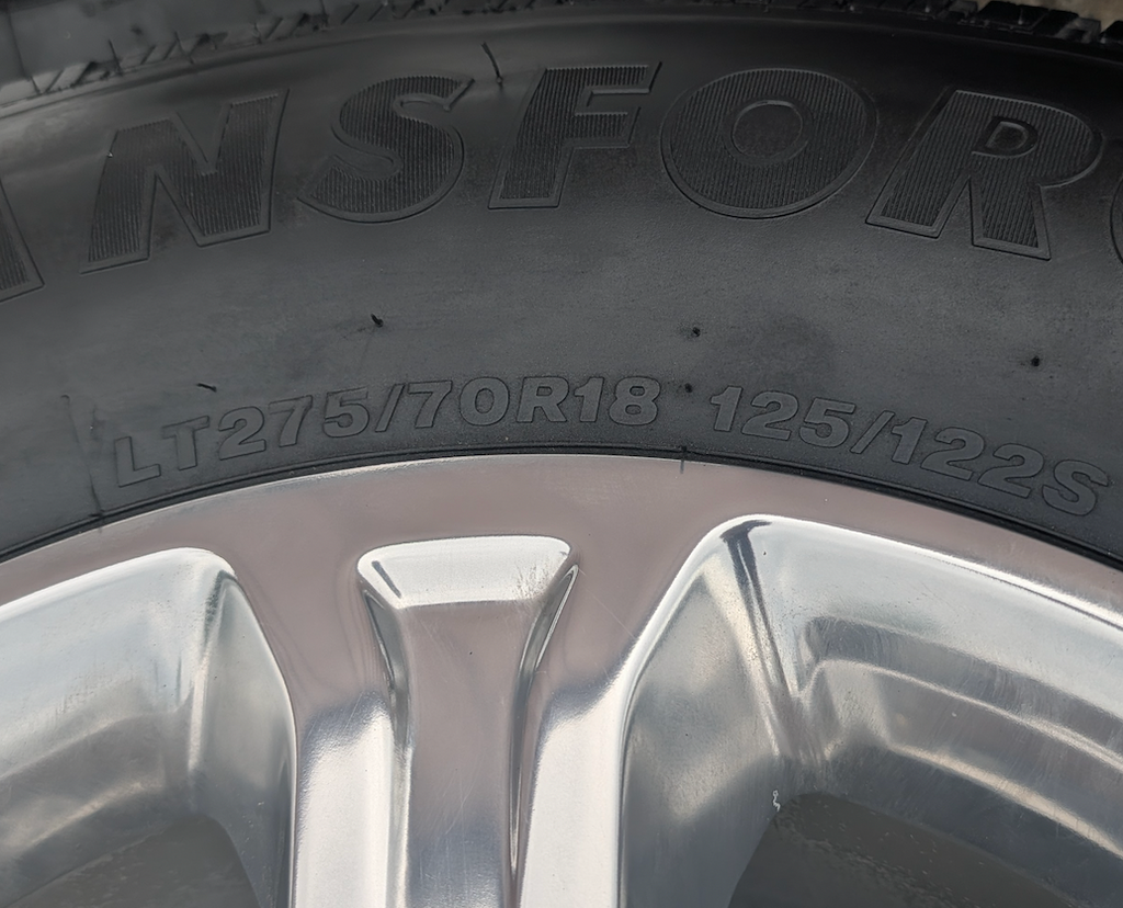 Polished Aluminum Ram 2500 / 3500 OEM 18” Wrapped in Firestone Transforce HT LT275/70R18