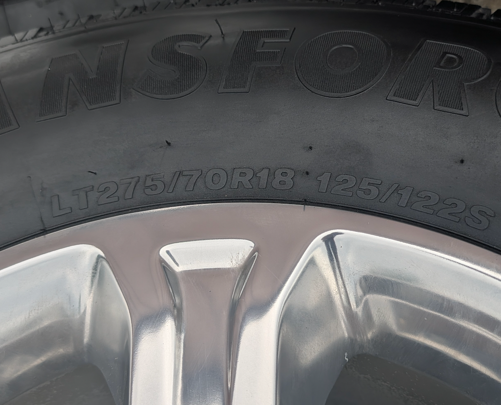 Polished Aluminum Ram 2500 / 3500 OEM 18” Wrapped in Firestone Transforce HT LT275/70R18
