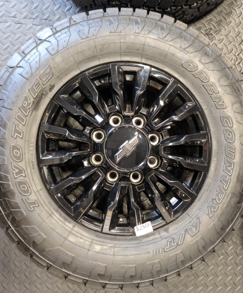 OEM 18” Chevrolet Silverado ZR2 2500HD / 3500HD Gloss Black Wheels wrapped in Toyo Open Country A/T tires.