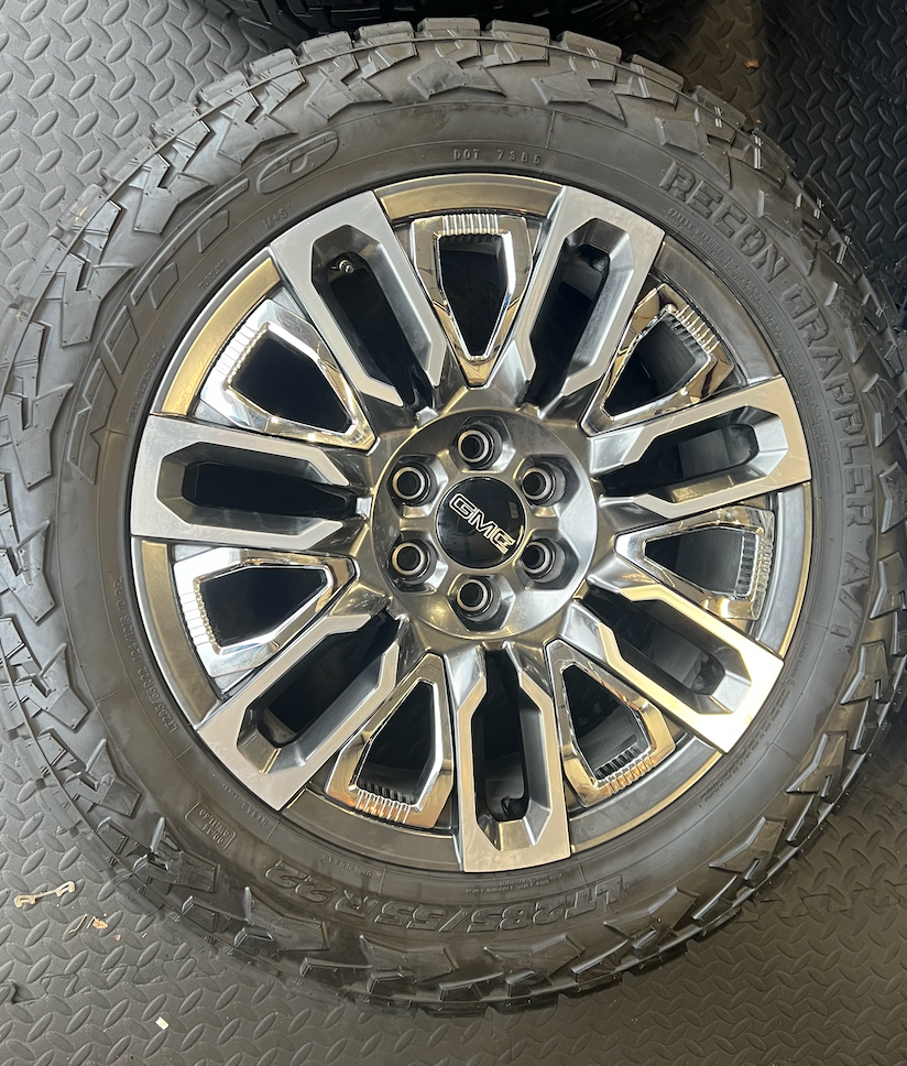 OEM 22”  Denali Ultimate Wheels with Charcoal Machined Finish & Chrome Inserts wrapped in Nitto Recon Grappler A/T tires.
