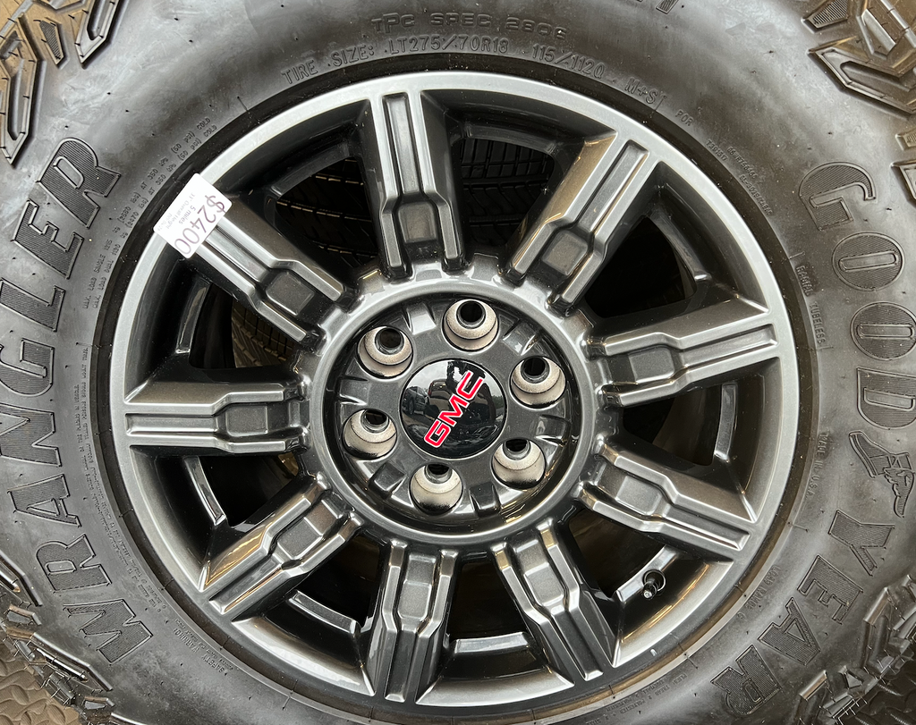 OEM 18" at4x machined aluminum Wheels wrapped in Goodyear tires.