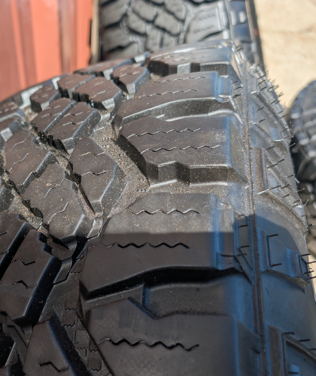 OEM 18” Ford F-250 / F-350 Tremor Wheels with Matte Black Finish wrapped in Goodyear Wrangler Duratrac tires.