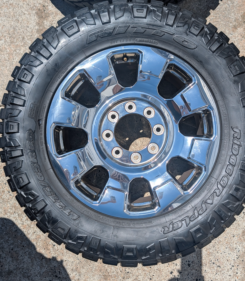 OEM 20” Chrome Ford F-250 / F-350 King Ranch / Lariat Wheels wrapped in LT275/65R20 Nitto Ridge Grappler tires.