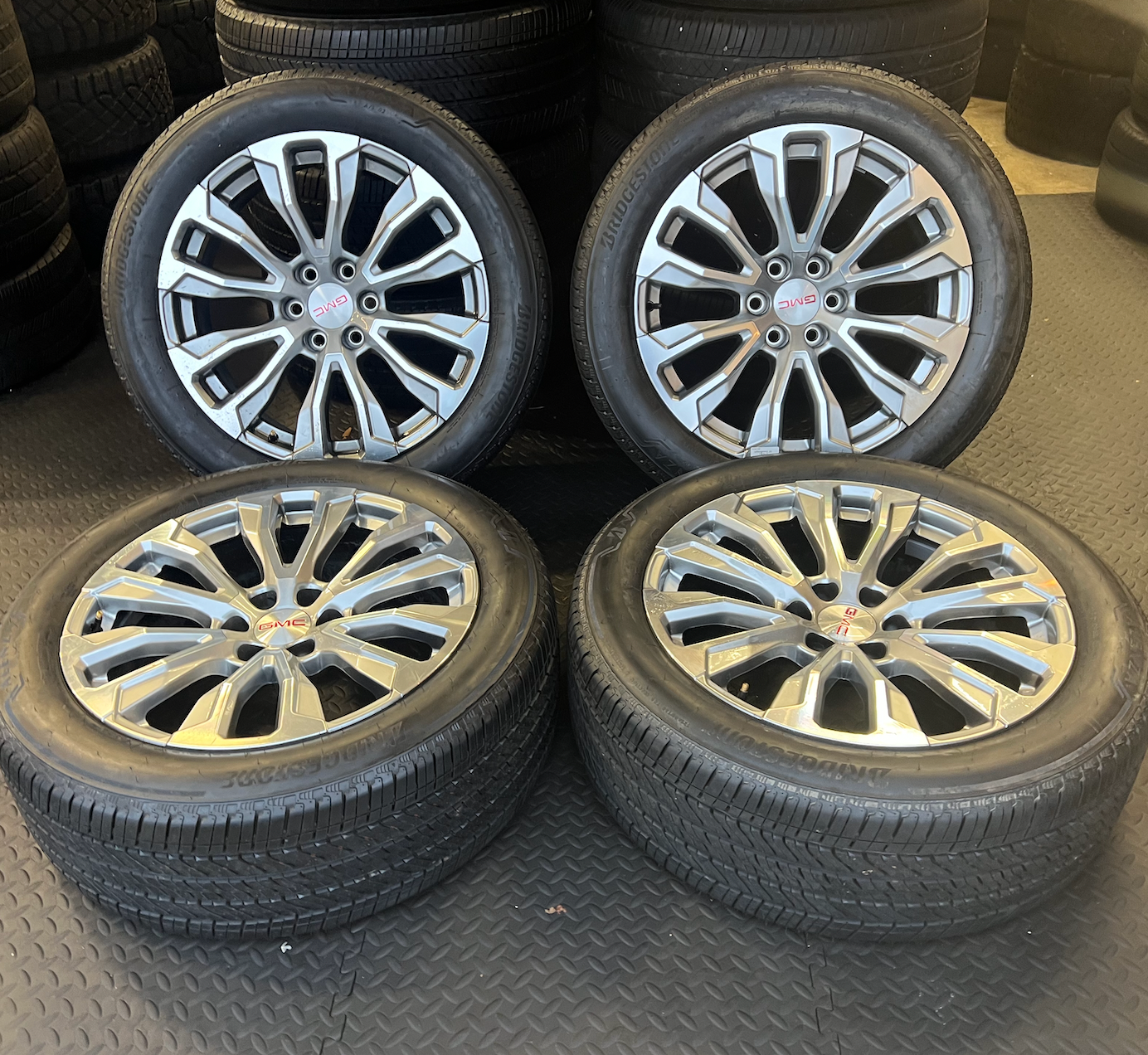 OEM 22” Denali Wheels with Machined & Grey Finish wrapped in Bridgestone tires.