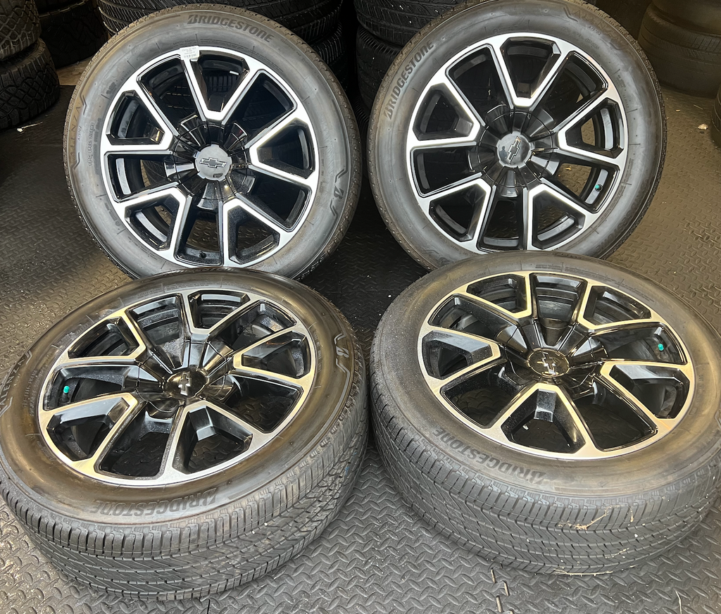 OEM 22” Black Machined Chevrolet Tahoe/Suburban Wheels wrapped in Bridgestone tires.