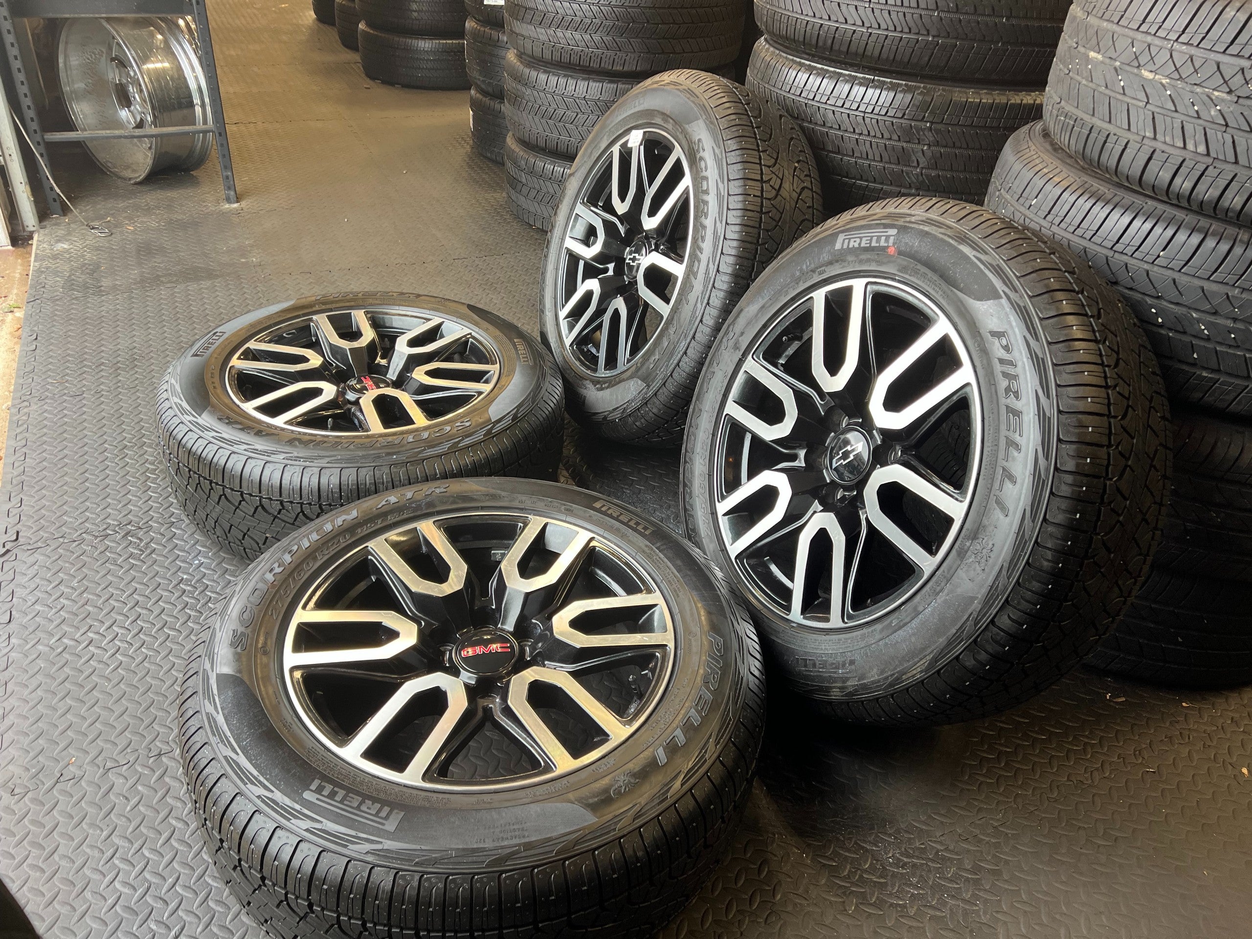 OEM 20” Gloss Black Wheels with Silver Inserts / Accents wrapped in 275/60R20 Pirelli Scorpion A/T tires.