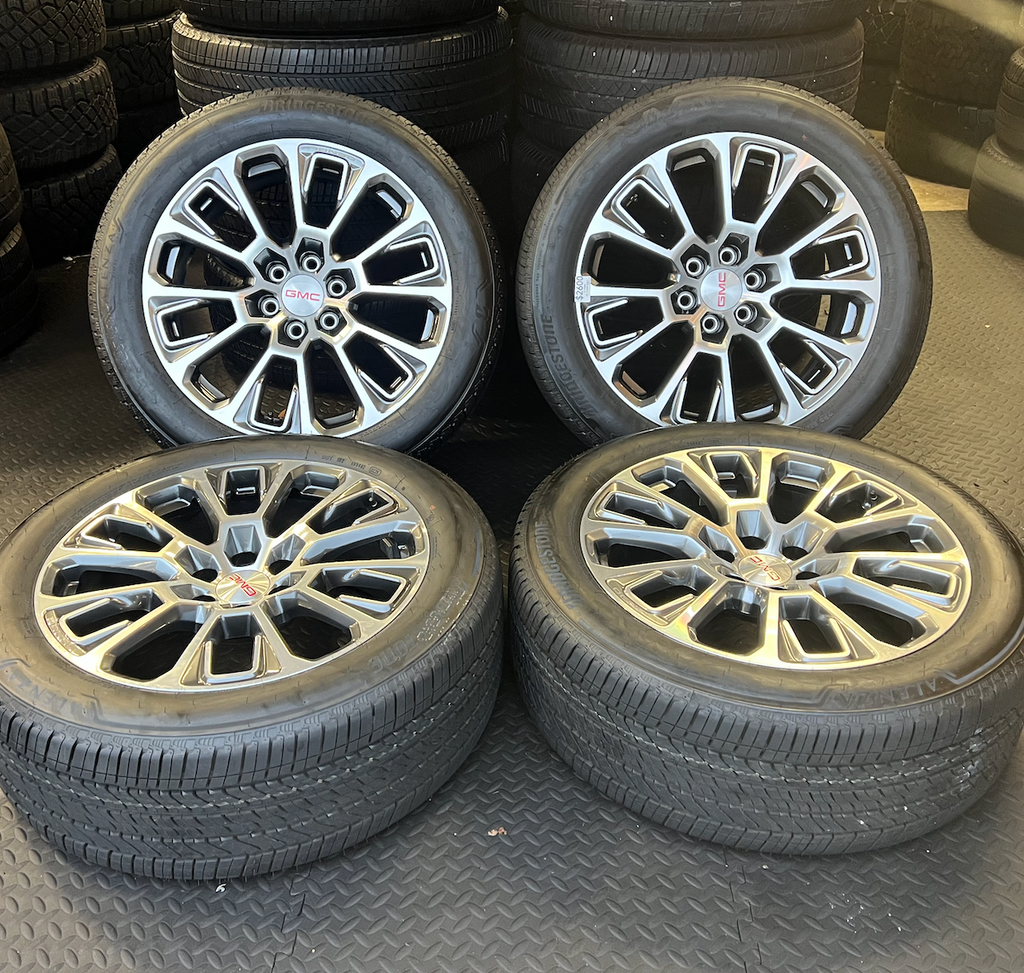 OEM 22” Machined Silver Denali Wheels wrapped in Bridgestone tires.