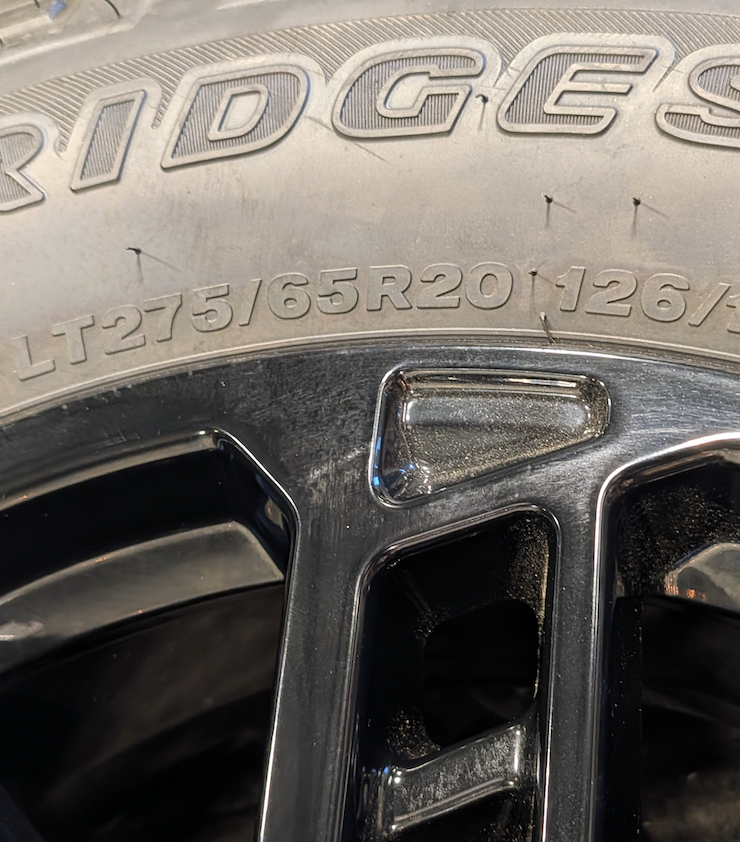 OEM 20” Gloss Black Ford F-250 / F-350 Wheels wrapped in Bridgestone Dueler A/T tires.