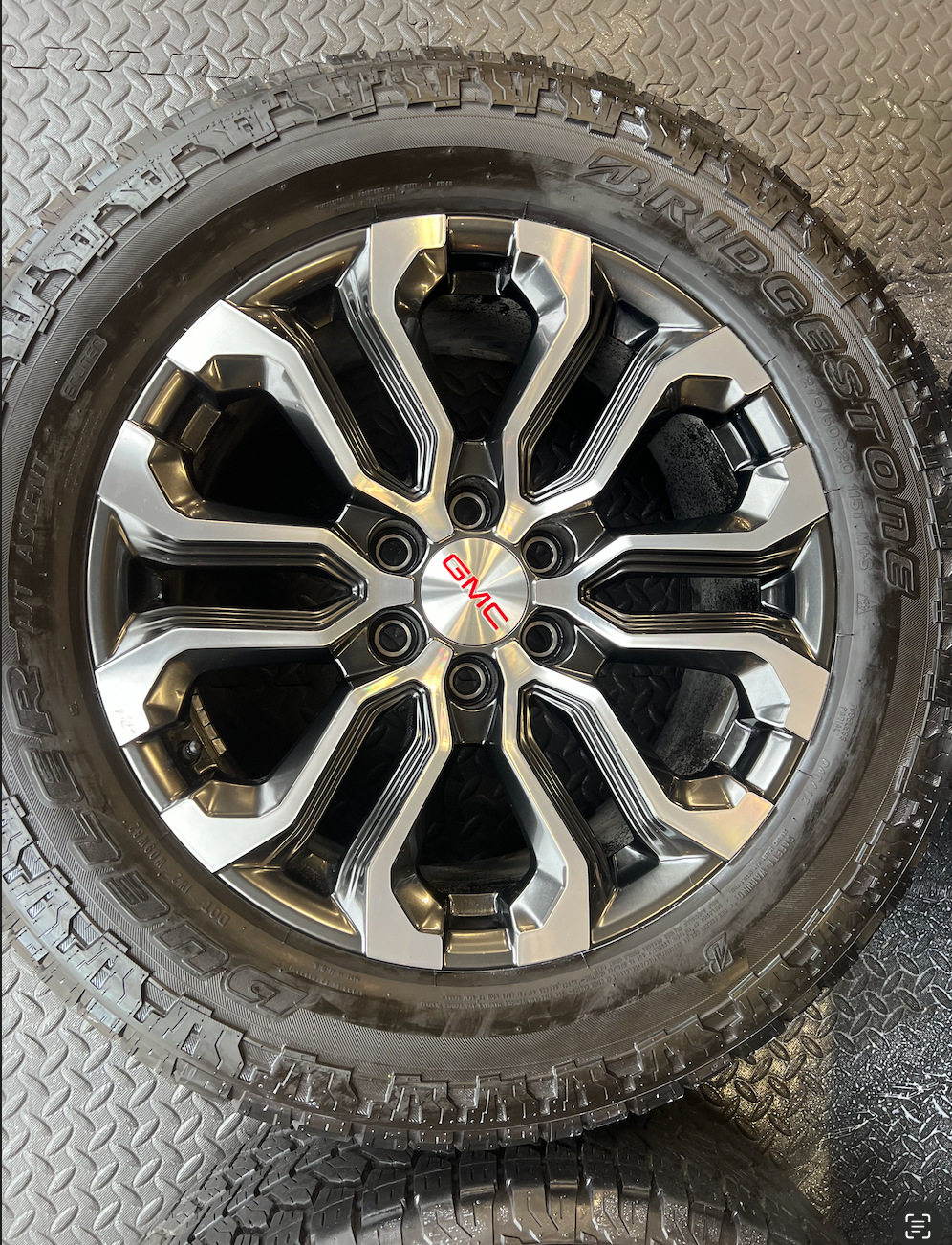 OEM 20” Charcoal Machined Wheels wrapped in Bridgestone Dueler A/T tires.