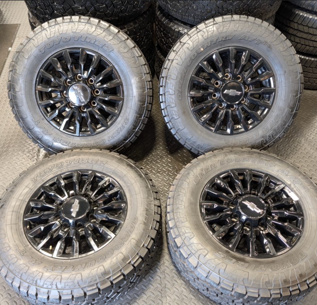 OEM 18” Chevrolet Silverado ZR2 2500HD / 3500HD Gloss Black Wheels wrapped in Toyo Open Country A/T tires.