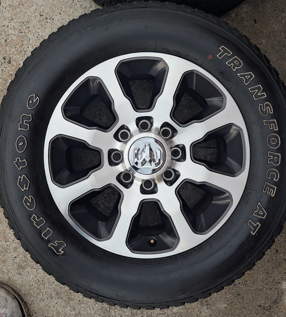 Machined 2500 / 3500 Laramie Longhorn OEM 20” Wrapped in Firestone Transforce A/T LT285/60R20