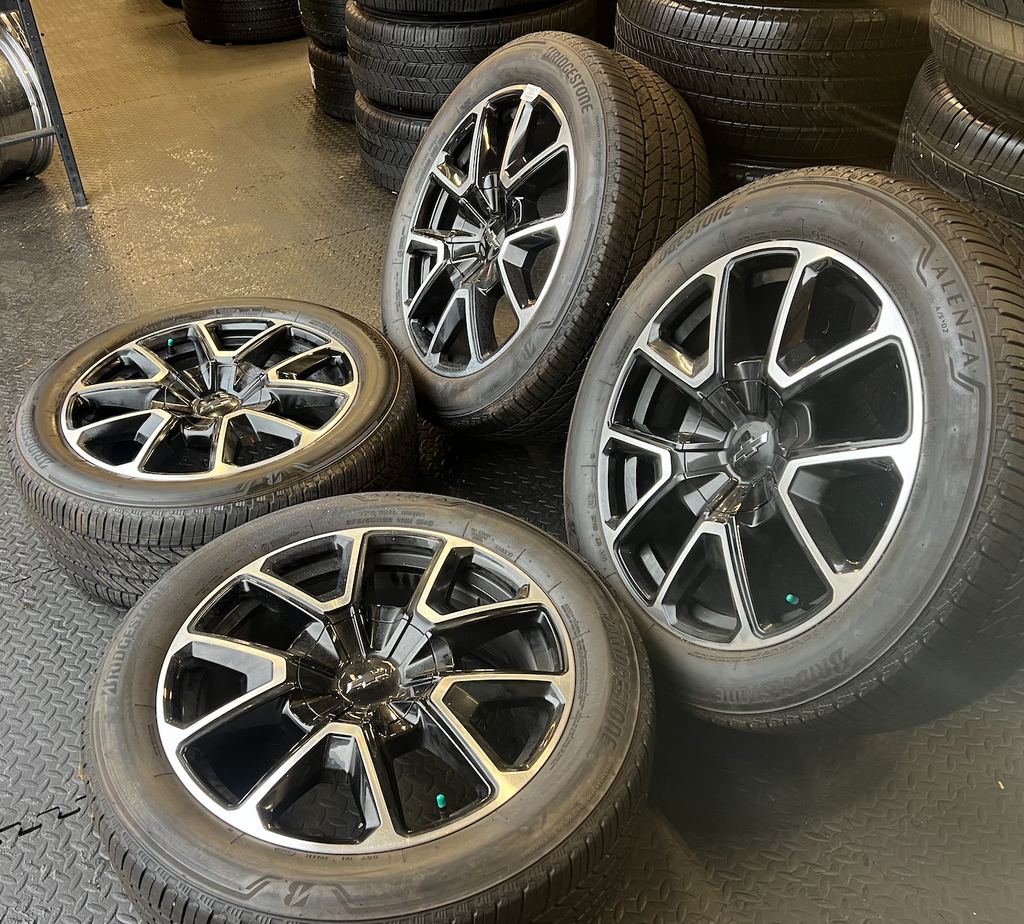 OEM 22” Black Machined Chevrolet Tahoe/Suburban Wheels wrapped in Bridgestone tires.