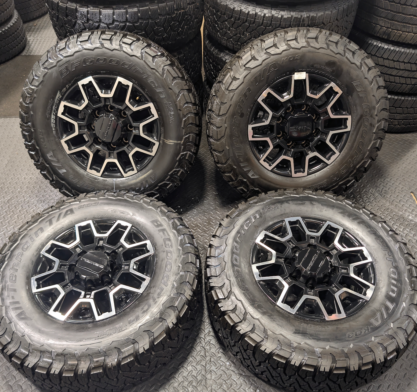 OEM 18” GMC Sierra 2500HD Wheels with Machined Black Finish wrapped in LT305/70R18 BFGoodrich All-Terrain T/A KO3 tires.