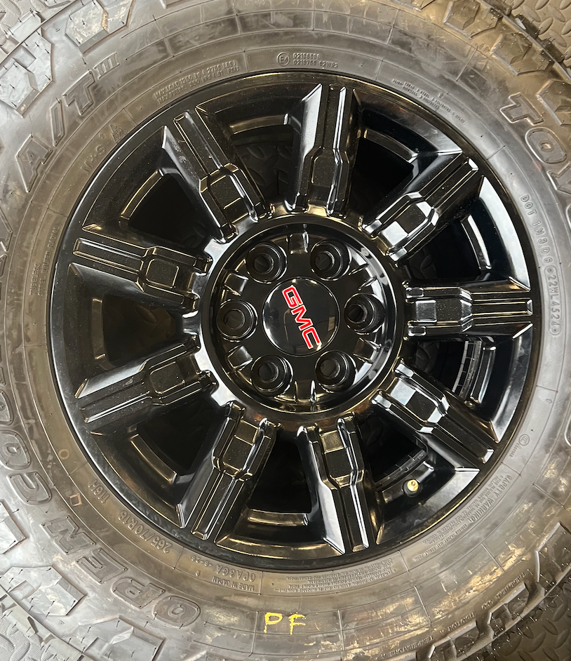 OEM 18” Gloss Black Wheels wrapped in Toyo Open Country A/T tires.