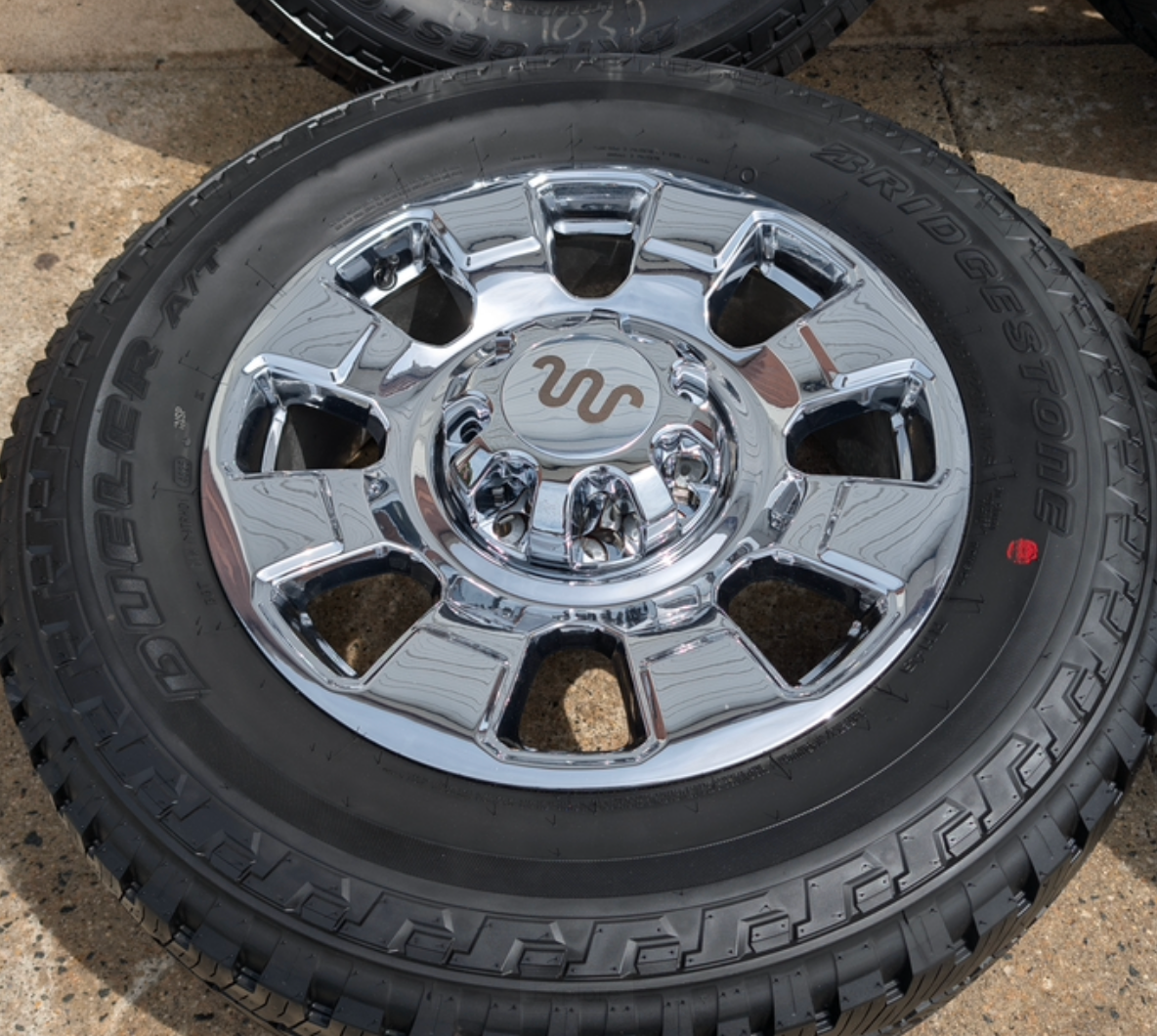 OEM 20” Chrome Ford F-250 / F-350 Wheels wrapped in Bridgestone Dueler A/T tires.