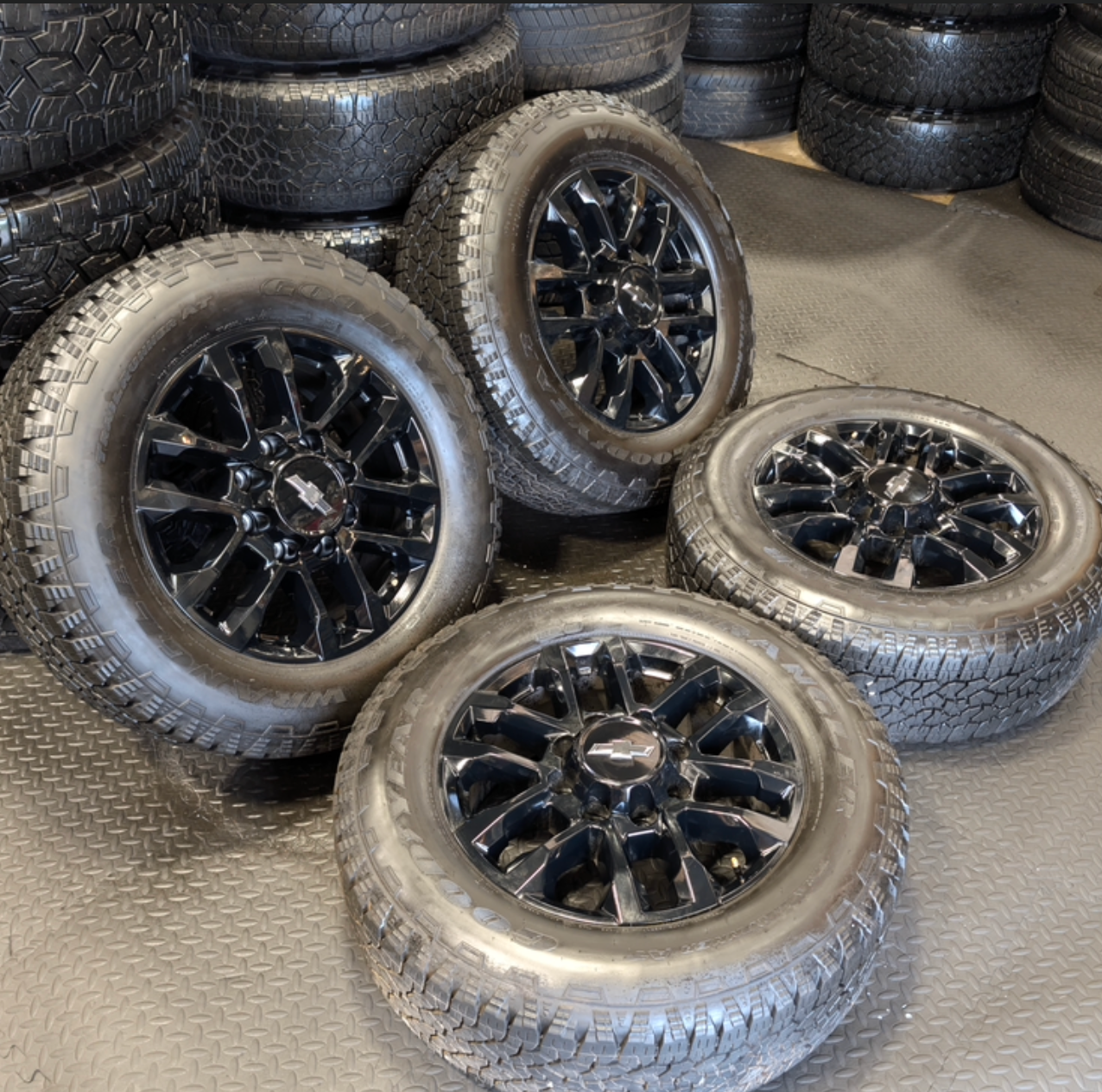 OEM 20” Gloss Black Chevrolet Silverado / GMC Sierra 2500HD & 3500HD Wheels wrapped in LT275/65R20 Goodyear Wrangler TrailRunner A/T tires.