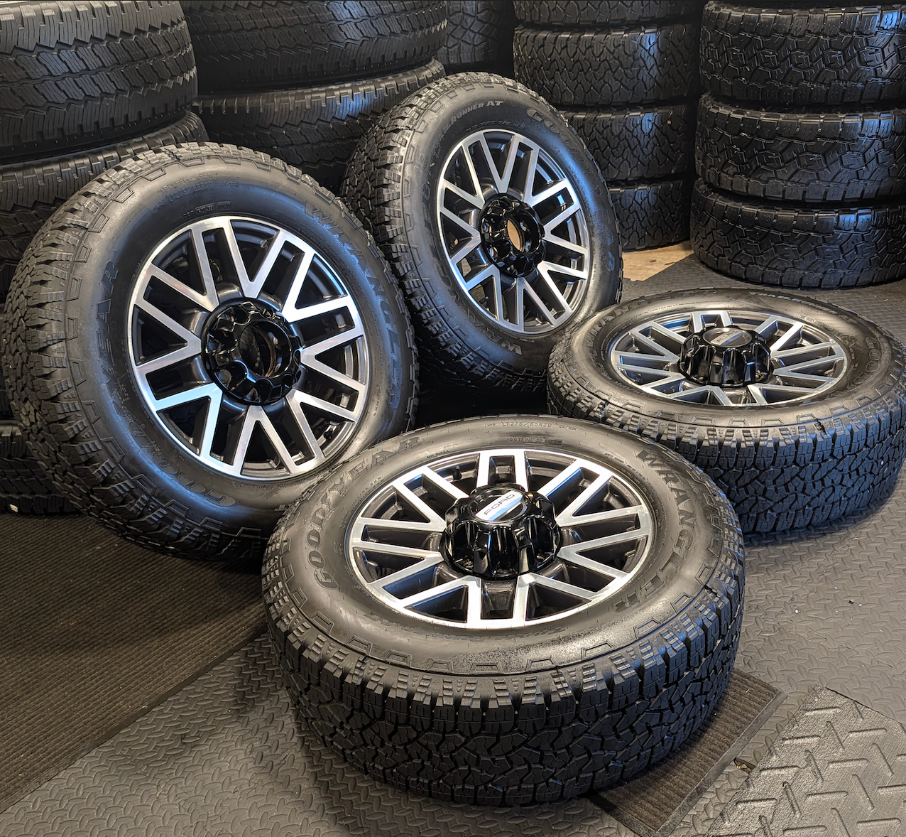 OEM 20” Machined Aluminum Ford F-250 / F-350 Super Duty Wheels wrapped in Goodyear Wrangler TrailRunner A/T tires.