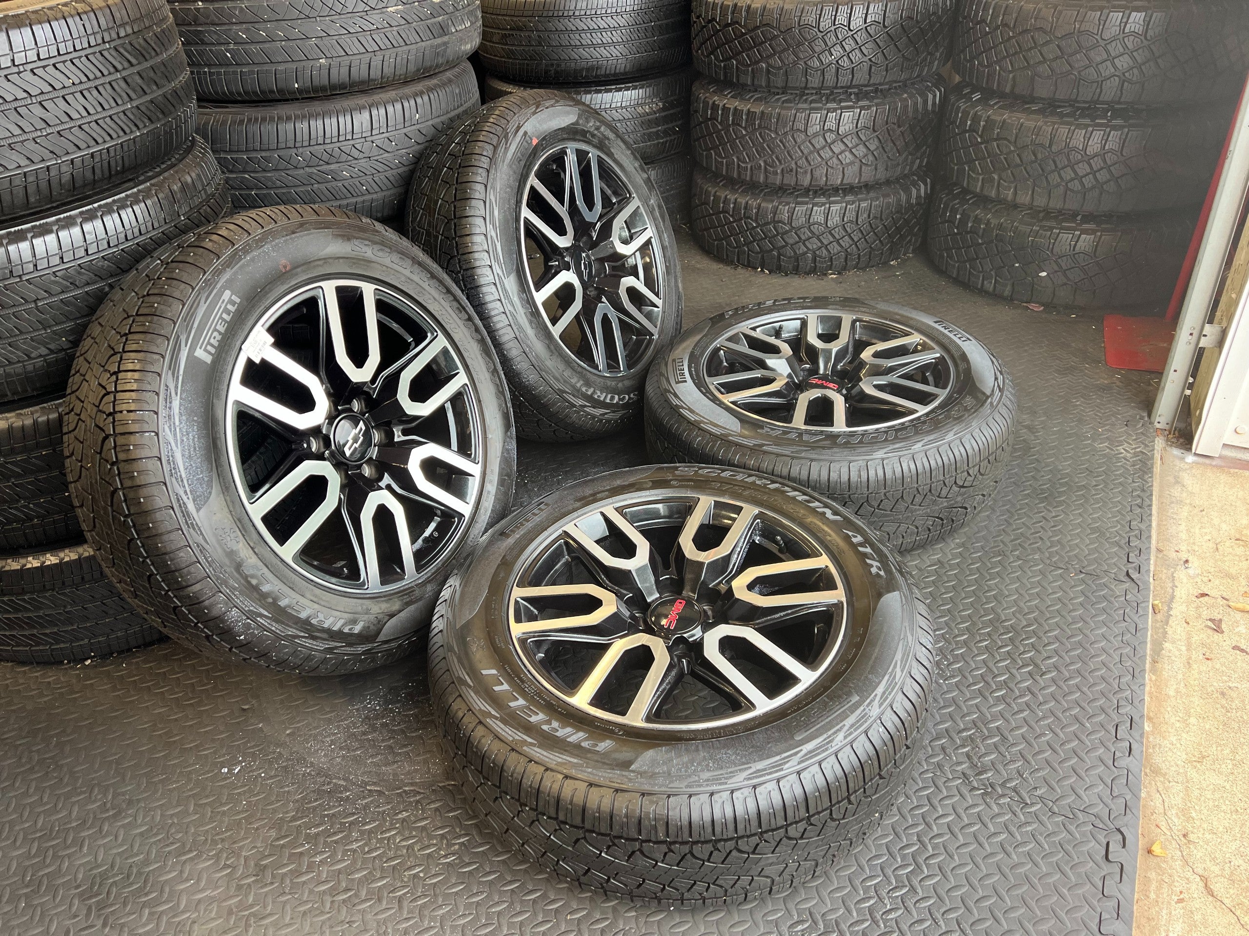 OEM 20” Gloss Black Wheels with Silver Inserts / Accents wrapped in 275/60R20 Pirelli Scorpion A/T tires.