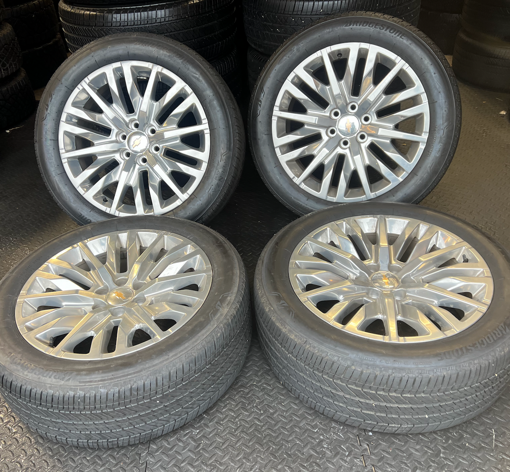 OEM 22” Polished 6-Split-Spoke Chevrolet Wheels wrapped in Bridgestone tires.